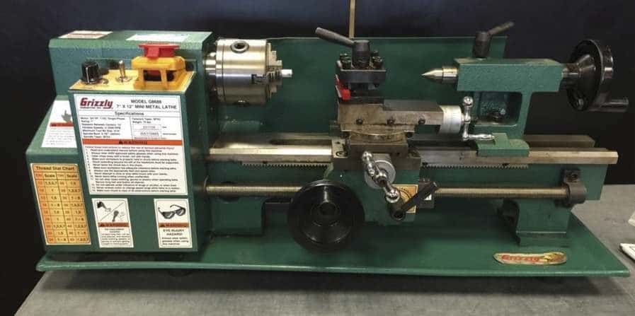 "Olive dark green colored Grizzly G8688 lathe machine on a benchtop"