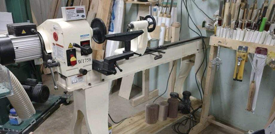"Shop Fox W1758 wood lathe standing inside a woodworking workshop"