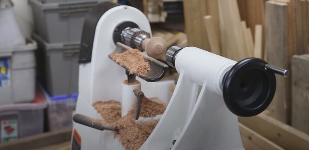"A white colored midi wood lathe in a workshop"