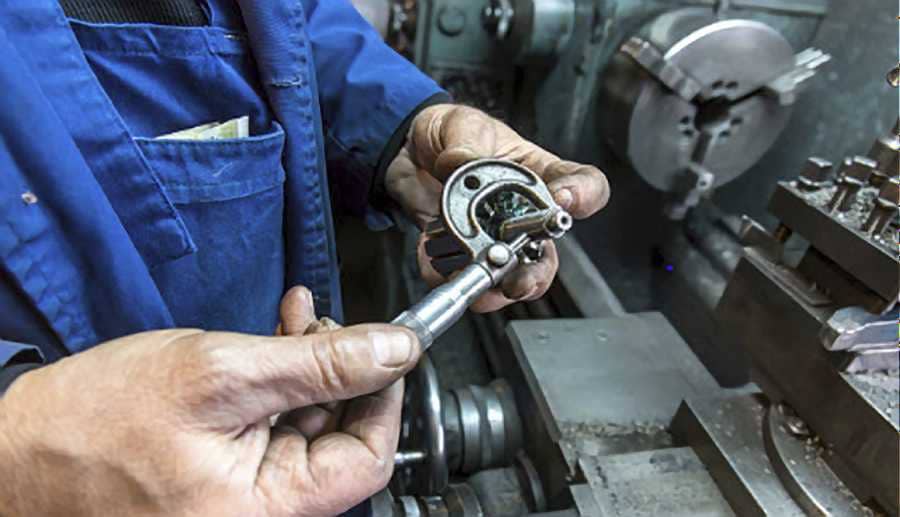 A guy testing his metal lathe and it's tools before working on the machine