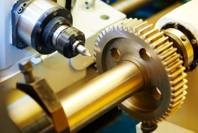 "picture showing few gears and parts of a metal lathe amchine"